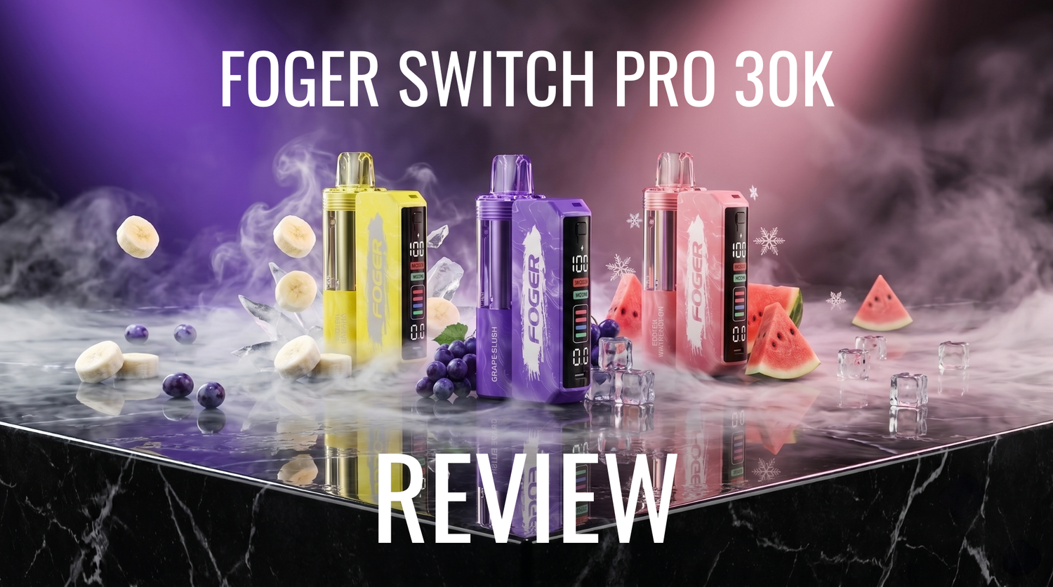 Promotional banner for the Foger Switch Pro 30K Review, featuring three modular vape devices in banana, grape slush, and watermelon flavors on a reflective black marble surface with ice cubes, fruit slices, and vapor.